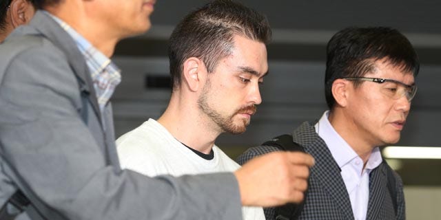 Sept. 23, 2015: Arthur Patterson, center, an American charged with murdering a Seoul university student in 1997, is escorted by South Korean police officers upon his arrival at Incheon International airport. (Im Hun-jung/Yonhap via AP)
