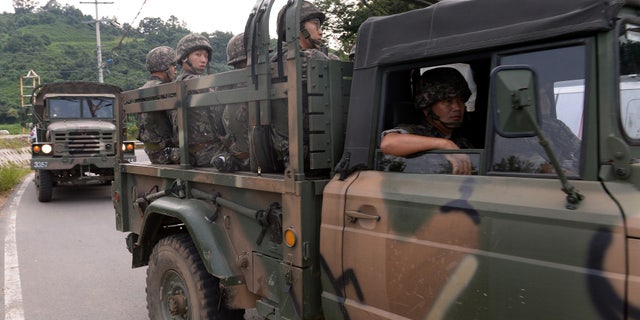 Aug. 21, 2015 - South Korean army soldiers ride on a truck in Yeoncheon, south of the demilitarized zone that divides the two Koreas. North Korean leader Kim Jong Un on Friday declared his frontline troops in a "quasi-state of war" and ordered them to prepare for battle.
