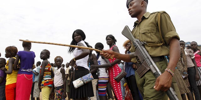 June 20, 2015: A policeman patrols as refugees from South Sudan queue to attend the celebrations to mark World Refugee Day.