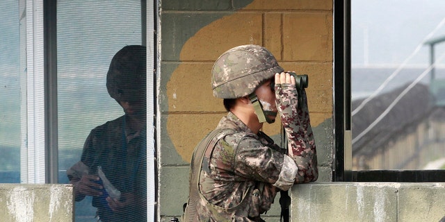 A South Korean army soldier looks through a pair of binoculars at a military check point at the Imjingak Pavilion near the border with North Korea.