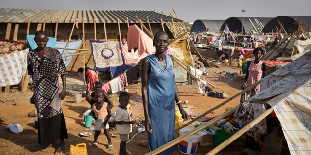 Dec. 31: A displaced family stand by their makeshift shelter at a United Nations compound which has become home to thousands of people displaced by the recent fighting, in the Jebel area on the outskirts of Juba, South Sudan.