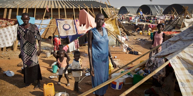 Dec. 31: A displaced family stand by their makeshift shelter at a United Nations compound which has become home to thousands of people displaced by the recent fighting, in the Jebel area on the outskirts of Juba, South Sudan.
