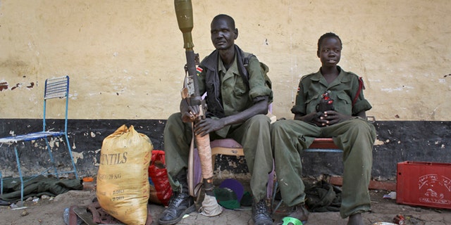Feb. 26, 2014: Rebels sit in the now-emptied hospital in Malakal, South Sudan.