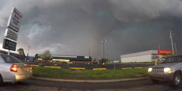 This frame taken from video provided by Brenton Leete shows a funnel cloud in part of a storm Wednesday, March 25, 2015, in Sand Springs, Okla. The slow start to the nation's tornado season came to a blustery end Wednesday when tornadoes hit Arkansas and Oklahoma. (AP Photo/Brenton Leete)