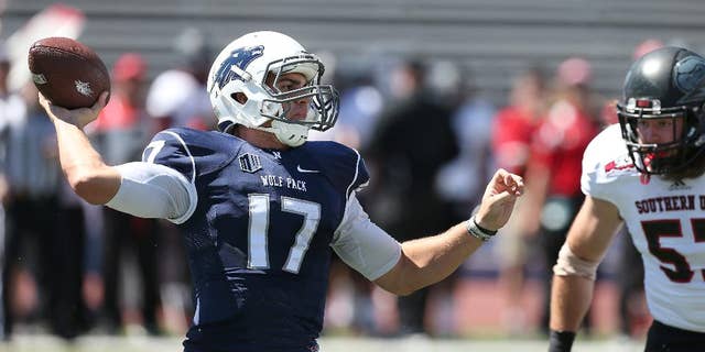 Nevada's Cody Fajardo (17) looks for an open receiver while being under pressure by Southern Utah's Josh Talbot (57) during the first half of an NCAA college football game on Saturday, Aug. 30, 2014, in Reno, Nev. (AP Photo/Cathleen Allison)