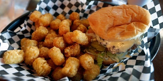 This Wednesday, Feb. 6, 2013 photo shows a hamburger and tater tots at a restaurant in Charlotte, N.C. Deep-fried foods may be causing trouble in the Deep South. People whose diets are heavy on them and sugary drinks were more likely to suffer a stroke, according to a new study released Thursday, Feb. 7, 2013. (AP Photo/Chuck Burton)