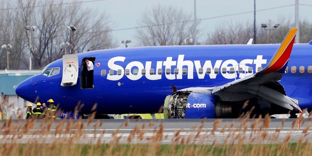 A Southwest Airlines plane sits on the runway at the Philadelphia International Airport after it made an emergency landing in Philadelphia, on Tuesday, April 17, 2018.