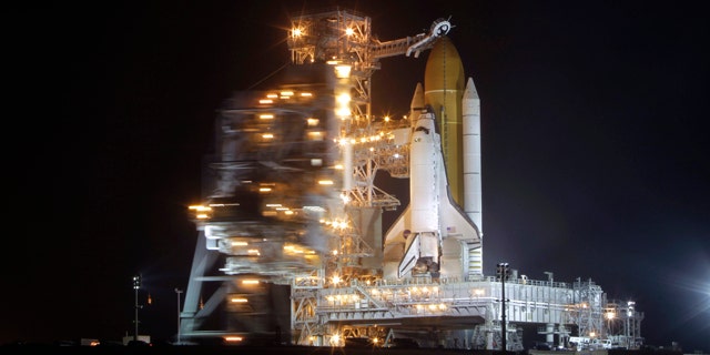 Space shuttle Discovery stands ready for launch at Pad 39A as the rotating service structure is moved back to expose the orbiter at the Kennedy Space Center in Cape Canaveral, Fla., Wednesday, Feb. 23, 2011.
