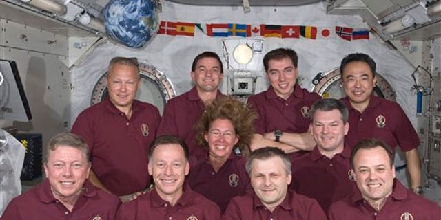 July 17: In this image provided by NASA the Expedition 28 crew and the STS-135 Atlantis astronauts take a break from a busy day in space to pose for a portrait aboard the orbiting complex's Kibo laboratory of the Japan Aerospace Exploration Agency. Left to right in the front row are Mike Fossum, Chris Ferguson, Andrey Borisenko and Ron Garan; in the middle row are Sandy Magnus and Alexander Samokutyaev; and the back row consists of Doug Hurley, Rex Walheim, Sergi Volkov and JAXA astronaut Satoshi Furukawa.
