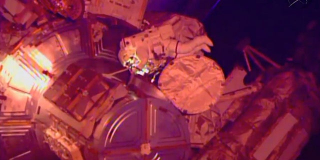 March 1, 2015: In this image from NASA television astronaut Terry Virts exits the Quest airlock hatch beginning the third spacewalk outside the International Space Station. (AP/NASA-TV)