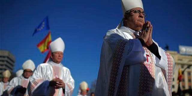 Bishops walk during a procession at a mass held in honor of the family in Madrid, Spain (AP Photo/Andres Kudacki)