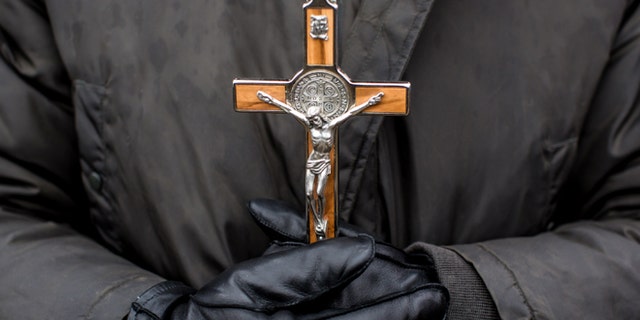 WASHINGTON, DC - JANUARY 25: An anti-abortion protester holds a crucifix at the March for Life on January 25, 2013 in Washington, DC. The pro-life gathering is held each year around the anniversary of the Roe v. Wade Supreme Court decision. (Photo by Brendan Hoffman/Getty Images)