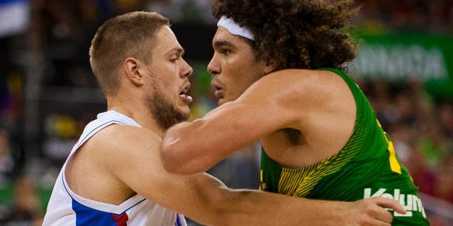 Brazil's Nene Hilario, right, fights for position with Serbia's Vladimir Stimac during the Group A Basketball World Cup match in Granada, Spain, Wednesday, Sept. 3, 2014. The 2014 Basketball World Cup competition will take place in various cities in Spain from Aug. 30 through to Sept. 14. (AP Photo/Daniel Tejedor)