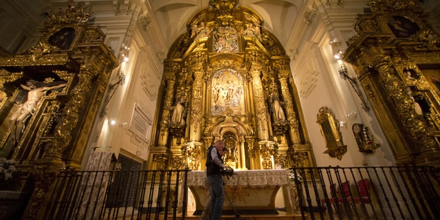 Two operators scan the altar with a Ground Penetration Radar at the Convent of the Barefoot Trinitarians in the historic Barrio de las Letras, or Literary Quarter in Madrid, Spain, Monday, April 28, 2014.