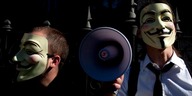 May 15, 2011: People wearing masks often used by a group that calls itself "Anonymous" take part in a rally in Madrid.