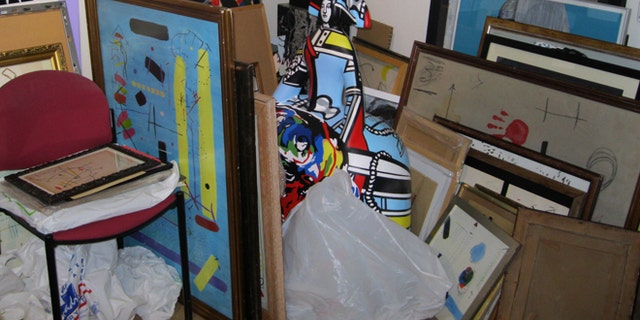 In this photo released by the Spanish Interior Ministry on Saturday, Feb. 28, 2015, different pieces of alleged fake art are seen inside a studio in Valencia, Spain. Spanish Police have broken up a network that allegedly created and sold fake works of art purporting to be by artists of international standing including Pablo Picasso, Andy Warhol and Joan Miro. Officers have arrested nine suspects in the eastern region of Valencia, including the alleged counterfeiters and intermediaries involved in selling the fakes. Investigators searched seven addresses and seized 271 works, including canvasses, sculptures and documents to be used to falsify the art's provenance. (AP Photo/Spanish Interior Ministry, HO)