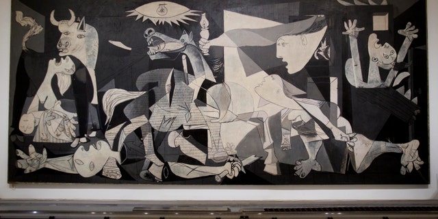 This Tuesday Feb. 21, 2012 photo of Pablo Picasso's "Guernica" painting is seen displayed at the Reina Sofia Museum in Madrid. (AP Photo/Paul White)