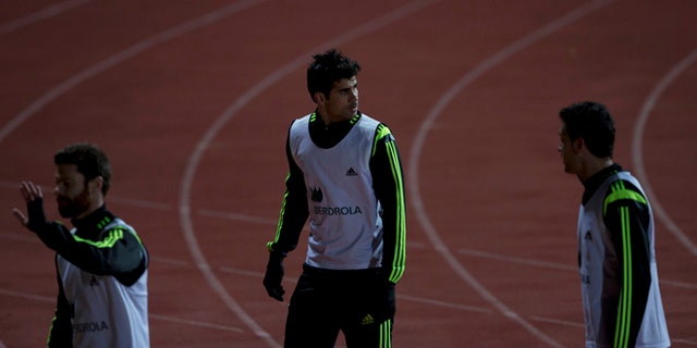 Diego Costa, center, leaves his first training session with Spain in Madrid, Monday March 3, 2014. Spain will play Italy Wednesday in a friendly soccer match. (AP Photo/Paul White)