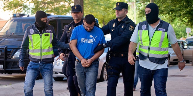 Police arrest a man suspected of belonging to a Jihadist recruiting network on June 16, 2014 in Madrid, Spain.
