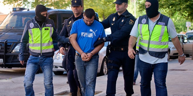Police arrest a man suspected of belonging to a Jihadist recruiting network on June 16, 2014 in Madrid, Spain.