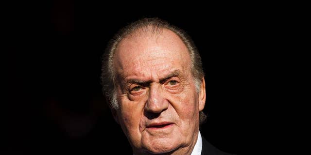 FILE - In this Tuesday, Dec. 27, 2011, file photo, Spain's King Juan Carlos leaves after the official opening of the Parliament, in Madrid. Carlos plans to abdicate and pave the way for his son, Crown Prince Felipe, to take over, Prime Minister Mariano Rajoy told the country Monday, June 2, 2014, in an announcement that was broadcast nationwide. The 76-year-old Carlos oversaw Spain's transition from dictatorship to democracy but has had health problems in recent years. (AP Photo/Daniel Ochoa de Olza, File)