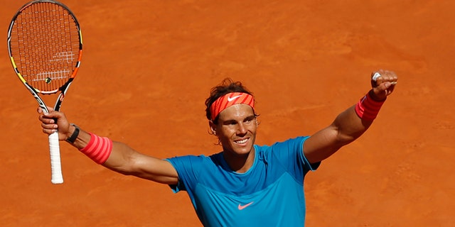 Rafael Nadal of Spain celebrates after winning his semifinal of the Madrid Open Tennis tournament in Madrid, Spain, Saturday, May 9, 2015. Nadal defeated Tomas Berdych of the Czech Republic 7/6, 6/1. (AP Photo/Daniel Ochoa de Olza)