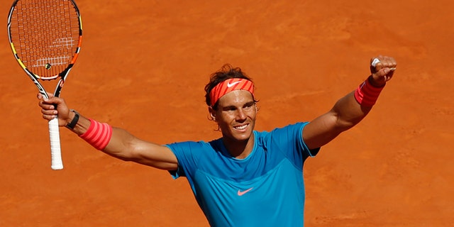 Rafael Nadal of Spain celebrates after winning his semifinal of the Madrid Open Tennis tournament in Madrid, Spain, Saturday, May 9, 2015. Nadal defeated Tomas Berdych of the Czech Republic 7/6, 6/1. (AP Photo/Daniel Ochoa de Olza)