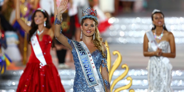Newly crowned Miss World Mireia Lalaguna Royo from Spain celebrates after at the end of the 2015 Miss World Grand Final in Sanya in south China's Hainan province Saturday Dec. 19, 2015. Spain's Mireia Lalaguna Royo was named the winner of the Miss World 2015 competition Saturday night in the southern Chinese island resort of Sanya, an event dogged by controversy over China's refusal to allow Canada's entrant to attend. (Chinatopix Via AP) CHINA OUT