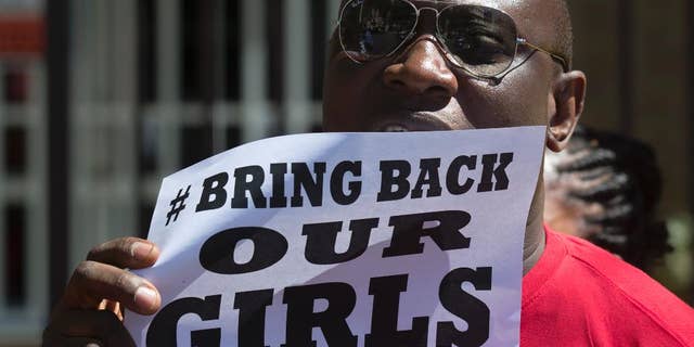 A Nigerian, resident in Spain protests outside the Nigerian embassy in Madrid, Spain, Friday, May 16, 2014 in support of the kidnapped school girls in Abuja, Nigeria. Boko Haram insurgents on April 15 abducted more than 300 students from the Chibok Government Girls Secondary School. Police say 53 managed to escape and 276 remain in captivity. (AP Photo/Paul White)
