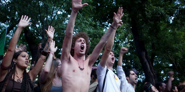 People shout slogans against the banks and the government in front of Interior Ministry building during a demostration Plaza de Sol, central Madrid Friday, Aug. 5, 2011. Police have prevented hundreds of anti-austerity protesters from entering the central plaza where they have held numerous demonstrations since May, railing against the political status quo.