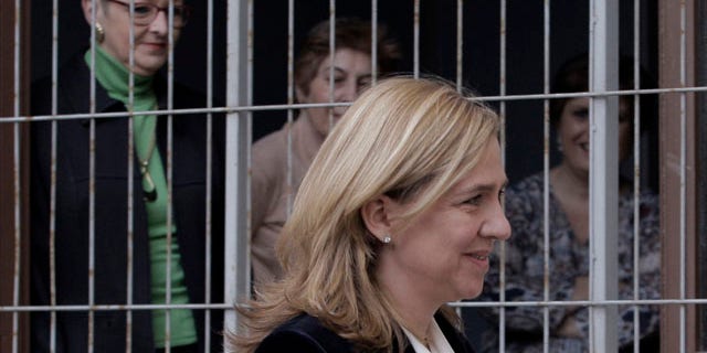 FILE - In this Feb. 8, 2014 file photo, court workers look out of a window as Spain's Princess Cristina arrives at the courthouse in Palma de Mallorca, Spain. (AP Photo/Manu Mielniezuk, File)