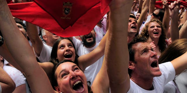Revelers hold up traditional red neckties as tens of thousands of people packed Pamplona's main square in Pamplona, northern Spain, Friday, July 6, 2012 to celebrate the start of Spain's most famous bull-running festival with the annual launch of the "chupinazo" rocket. Perhaps best glorified by Ernest Hemingway's 1926 novel "The Sun Also Rises," the San Fermin festival is known around the world for the daily running of the bulls. (AP Photo/Alvaro Barrientos)
