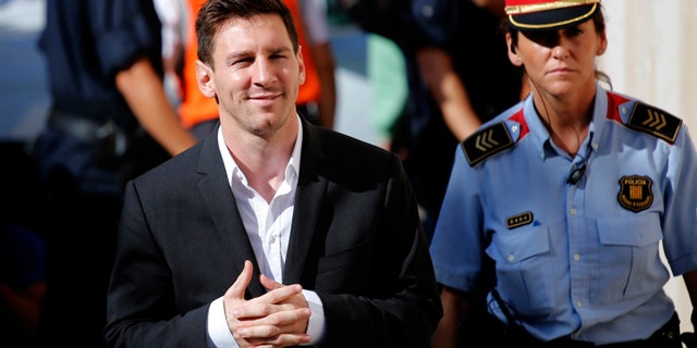 FILE - In this Sept. 27, 2013 file photo, FC Barcelona star Lionel Messi, left, arrives at a court to answer questions in a tax fraud case in Gava, near Barcelona, Spain. Spanish court officials say Lionel Messi's tax fraud trial has been set for May 31-June 3, 2016. Messi and his father, Jorge Horacio Messi, have been charged with three counts of tax fraud and could be sentenced to nearly two years in prison if found guilty. They are accused of defrauding Spain's tax office of 4.1 million euros ($4.4 million) in unpaid taxes from 2007-09. (AP Photo/Emilio Morenatti, File)