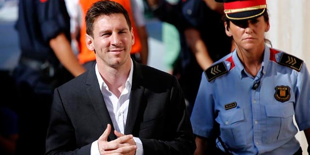 FILE - In this Sept. 27, 2013 file photo, FC Barcelona soccer player Lionel Messi, left, arrives at a court to answer questions in a tax fraud case in Gava, near Barcelona, Spain. A Barcelona court on Friday July 6, 2016 sentenced Lionel Messi and his father Jorge Horacio Messi to suspended sentences of 21 months in prison each for tax fraud. The court found them guilty of three counts of tax fraud each. (AP Photo/Emilio Morenatti, File)