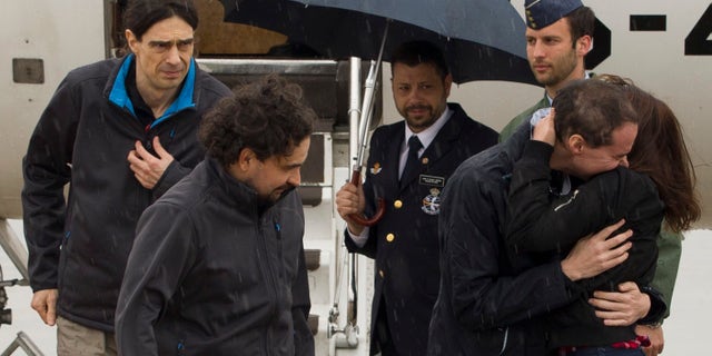 In this photo made available by Presidencia del Gobierno on Sunday, May 8, 2016, the three freed Spanish journalists Antonio Pampliega, right, Jose Manuel Lopez, left, and Angel Sastre, arrive at the Torrejon military airbase in Madrid, Spain. Three Spanish journalists who went missing while working in Syria in July were freed from captivity, the Spanish government said on Saturday. Antonio Pampliega, Jose Manuel Lopez and Angel Sastre disappeared near the city of Aleppo in northern Syria on July 12. (Pool Moncloa via AP)