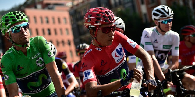 Sky's Team Christopher Froome of Britain, right, waits beside shirt race leader, Movistar's Team Nairo Quintana of Colombia, center, and team mate Alejandro Valverde of Spain, before the start of the 13th stage between Bilbao and Urdax Dantxarinea, 213,4 kilometers (132,6 miles), of the Spanish Vuelta cycling race that finish in Bilbao, northern Spain, Friday, Sept. 2, 2016. (AP Photo/Alvaro Barrientos)