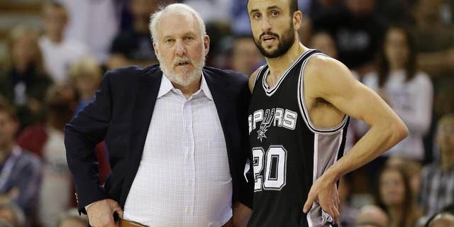 FILE - In this Nov. 15, 2014, file photo, San Antonio Spurs head coach Gregg Popovich talks with Spurs guard Manu Ginobili during the second half of an NBA basketball game against the Sacramento Kings in Sacramento, Calif. Their first days together were difficult, but Ginobili and Popovich eventually found common ground. In doing so, they made each other, and the San Antonio Spurs, so much better. (AP Photo/Rich Pedroncelli, File)