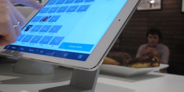 Catherine Seay demonstrates the use of Square point-of-sale software at the Curators Coffee Gallery in central London.