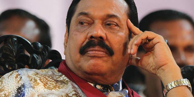 FILE - In this Jan. 5, 2015 file photo, then-Sri Lankan President Mahinda Rajapaksa attends his final public rally for the presidential elections in Kesbewa, southeast of Colombo, Sri Lanka. Mangala Samaraweera, the spokesman for new President Maithripala Sirisena, said Sunday, Jan. 11, 2015, Sri Lanka's new government will investigate an alleged attempt by former President Rajapaksa to stage a coup to stay in power when results showed he was losing last week's election. (AP Photo/Sanka Gayashan, File)