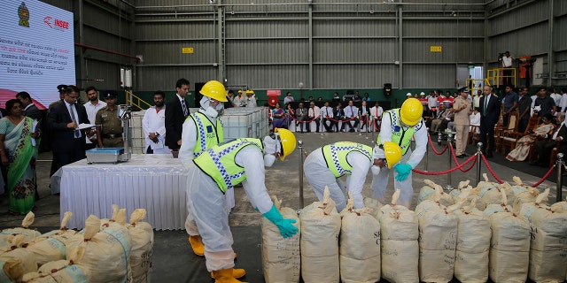 Sri Lankan police officers in protective outfits prepare to destroy a haul of seized cocaine during a ceremony at an industrial facility in Katunayaka, outskirts of Colombo, Sri Lanka in January.