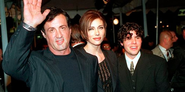 Dec. 5, 1996: In this file photo, Sylvester Stallone, left, star of the film "Daylight," arrives at the film's world premiere with his girlfriend Jennifer Flavin, center, and his son Sage Stallone, who co-stars in the film, in Hollywood district of Los Angeles.