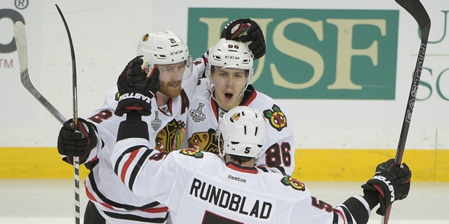 June 3, 2015: Chicago Blackhawks left wing Teuvo Teravainen (86), celebrates his goal with Duncan Keith (2) and David Rundblad (5) during the third period in Game 1 of the NHL Stanley Cup Final against the Tampa Bay Lightning in Tampa, Fla. (AP Photo/Phelan M. Ebenhack)