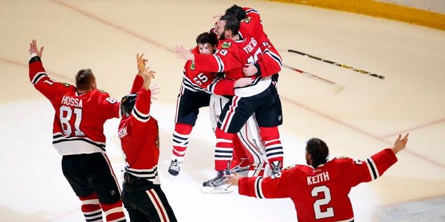 June 15, 2015: Members of the Chicago Blackhawks celebrate after defeating the Tampa Bay Lightning in Game 6 of the Stanley Cup Final seriesin Chicago. The Blackhawks defeated the Lightning 2-0 to win the series 4-2. (AP Photo/Charles Rex Arbogast)