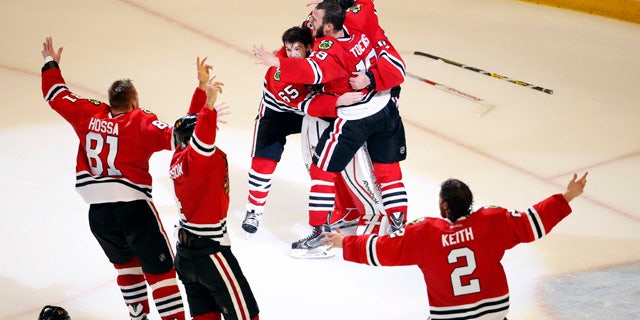 June 15, 2015: Members of the Chicago Blackhawks celebrate after defeating the Tampa Bay Lightning in Game 6 of the Stanley Cup Final seriesin Chicago. The Blackhawks defeated the Lightning 2-0 to win the series 4-2. (AP Photo/Charles Rex Arbogast)
