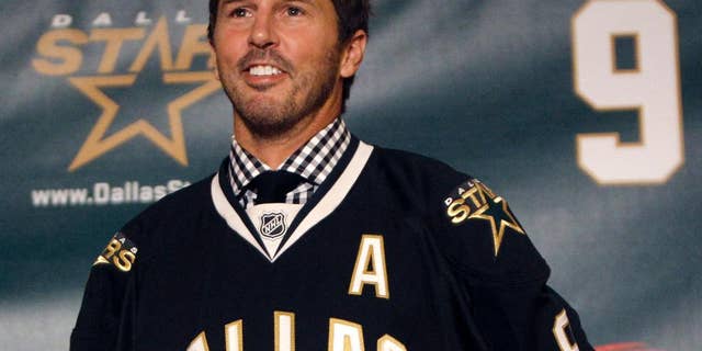 FILE - In this Sept. 23, 2011, file photo, NHL hockey player Mike Modano wears a Dallas Stars jersey during a news conference announcing his retirement in Dallas. Modano had several tearful farewells as his playing days wound down. The guy who made hockey cool in Dallas figures he'll get emotional again for the final ceremony: retiring his iconic No. 9 during the Stars' game against Minnesota on Saturday, March 8. (AP Photo/LM Otero, File)