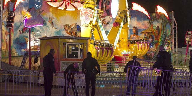 October 24, 2013: Fairgrounds Police secure a barricade around the Vortex after an accident closed the ride just after 9 p.m. at the N.C. State Fair in Raleigh, N.C. (AP Photo)