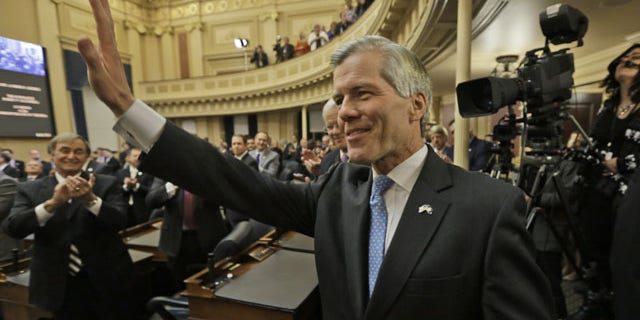 January 8, 2014: Virginia Gov. Bob McDonnell waves to the crowd after delivering his final State of the Commonwealth address before a joint session of the 2014 General Assembly at the Capitol in Richmond. McDonnell leaves office on Saturday. (AP Photo/Steve Helber)