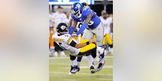 FILE - In this Aug. 9, 2014, file photo, New York Giants defensive end Jason Pierre-Paul (90) pressures Pittsburgh Steelers quarterback Bruce Gradkowski (5) on a throw in the first quarter of a preseason NFL football game in East Rutherford, N.J. Pierre-Paul is starting to show signs that he is over the injuries that limited his effectiveness last season. (AP Photo/Bill Kostroun, File)