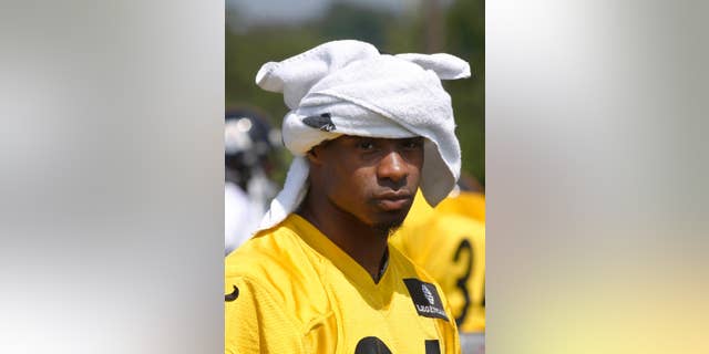 Pittsburgh Steelers cornerback Ike Taylor (24) uses a towel for a hat during NFL football training camp in Latrobe, Pa., on Monday, Aug. 4, 2014 . (AP Photo/Keith Srakocic)