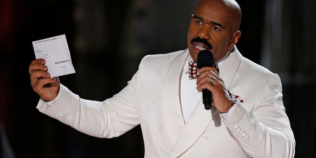 Steve Harvey holds up the card showing the winners after he incorrectly announced Miss Colombia Ariadna Gutierrez at the winner at the Miss Universe pageant Sunday, Dec. 20, 2015, in Las Vegas. According to the pageant, a misreading led the announcer to read Miss Colombia as the winner before they took it away and gave it to Miss Philippines Pia Alonzo Wurtzbach.(AP Photo/John Locher)